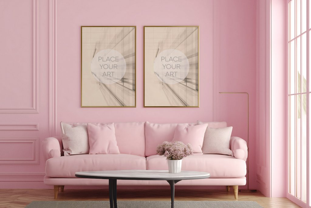 Two vertical gold frames mockup hanging side by side over a plush pink sofa in a monochrome pink vintage living room with classic wall moldings.