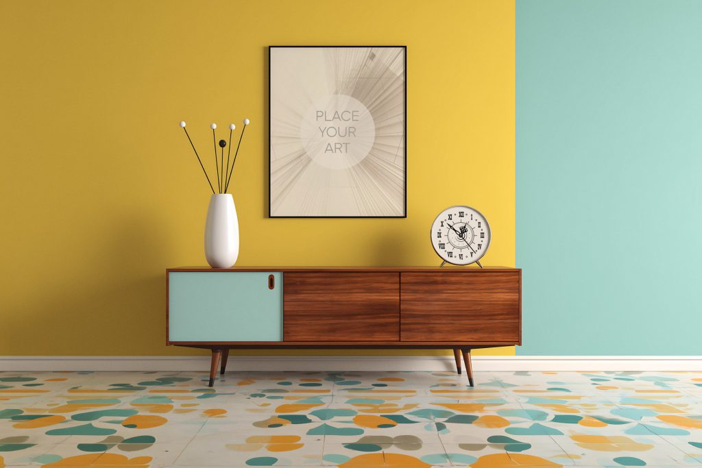 vertical-black-frame-mockup-color-block-wall-retro-terrazzo-floor.jpg Vertical black frame mockup centered on a yellow and teal color-block wall above a mid-century wooden sideboard and a retro terrazzo tile floor.