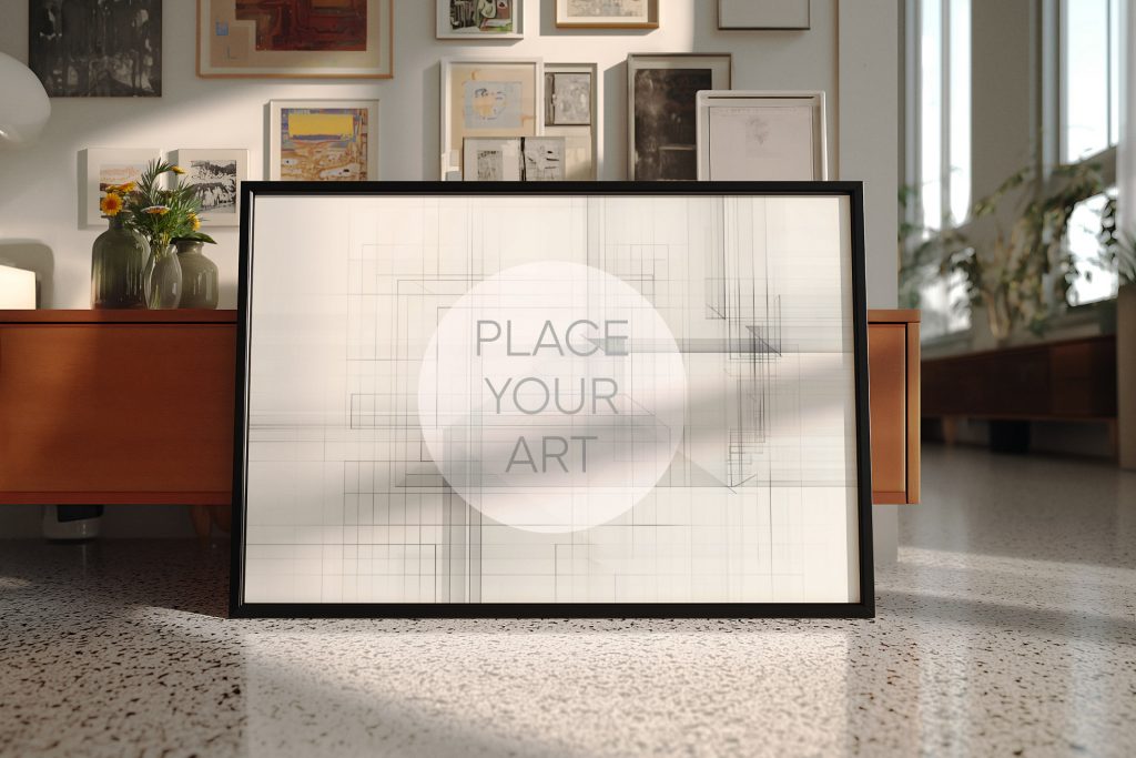 wall-art-frame-mockup-atomic-era-retro-landscape-terrazzo-living-room.jpg Horizontal black wall art frame mockup leaning on a terrazzo floor in a mid-century modern living room with a vintage sideboard and gallery wall.