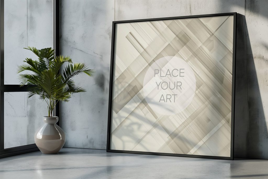 Large square wall art mockup template leaning in a concrete studio corner next to a modern ceramic pot with a green plant under soft window light.