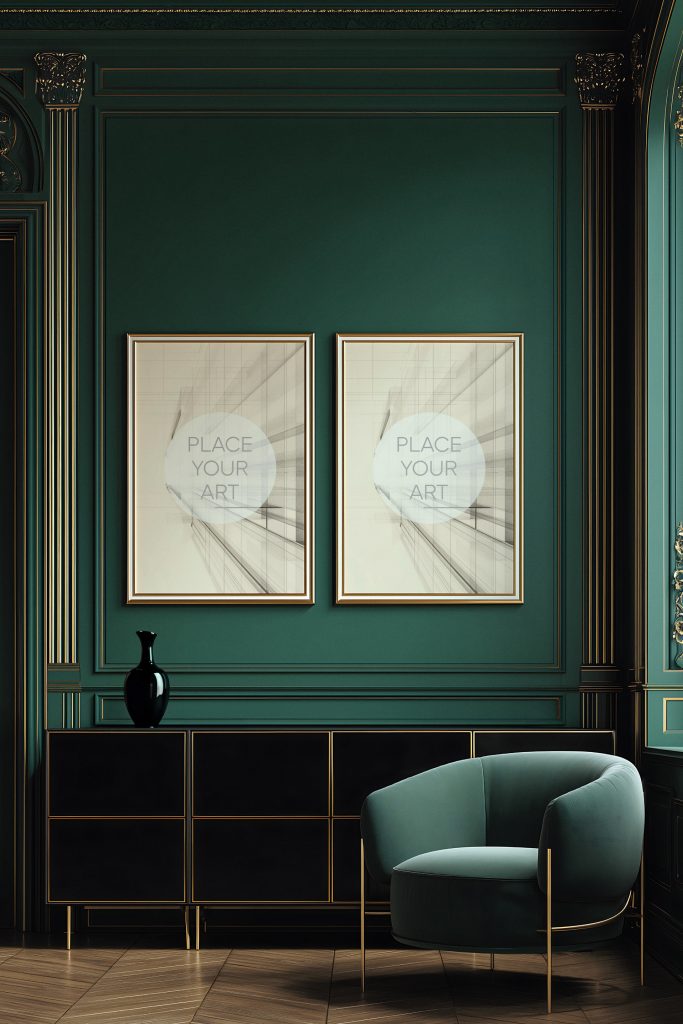 dual-gold-frame-mockup-emerald-green-wainscoting-velvet-chair.jpg Two vertical gold frames hanging on a deep emerald green wall with gold trim moldings above a black sideboard and a teal velvet armchair.