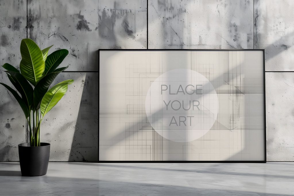 Large horizontal wall art mockup leaning on a polished concrete floor against an industrial cement panel wall, styled with a vibrant green tropical plant in a black minimalist pot under natural sunlight.