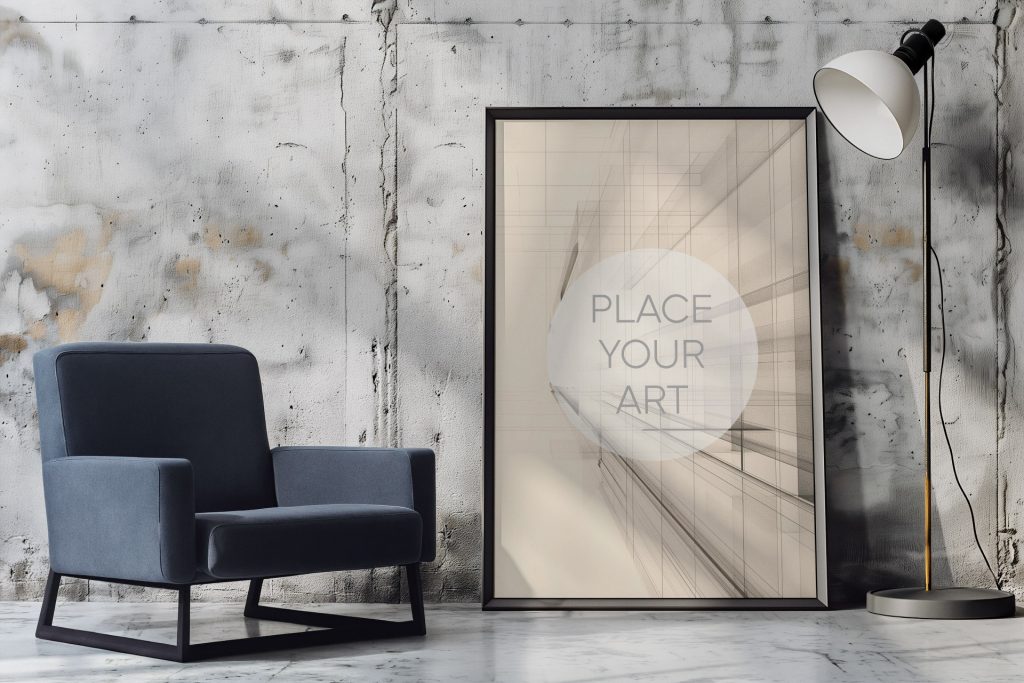 Vertical large wall art mockup leaning on a concrete floor against a weathered cement panel wall, featuring a modern grey armchair and a minimalist industrial floor lamp under soft room lighting.