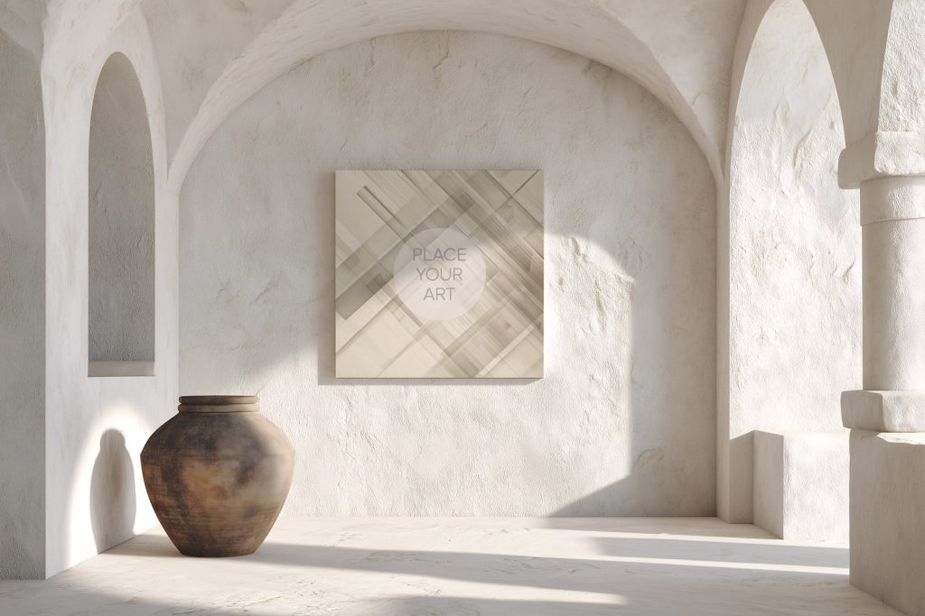 Square wall art mockup on a textured lime-washed plaster wall under a minimalist archway with a large rustic ceramic vase and dramatic sunlight shadows.