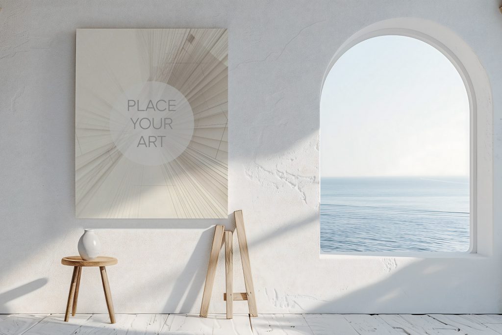 Large vertical wall art mockup on a white lime-washed wall next to an arched window with a calm blue sea view and a rustic wooden stool.