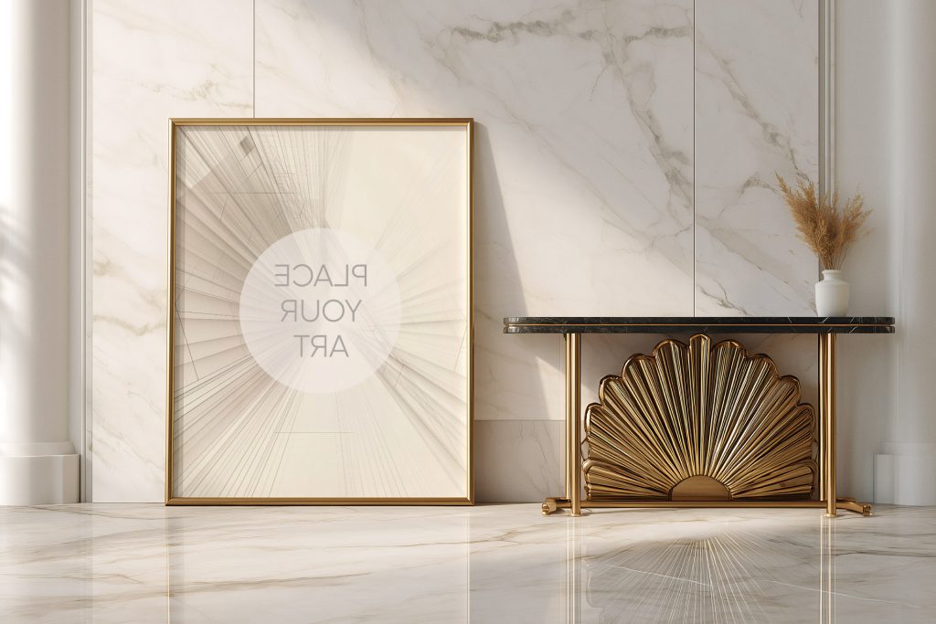Vertical gold frame poster mockup leaning against a white marble wall next to a golden sunburst Art Deco console table with pampas grass.